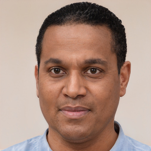 Joyful latino adult male with short  black hair and brown eyes