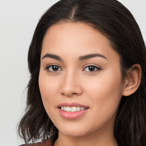 Joyful white young-adult female with long  brown hair and brown eyes