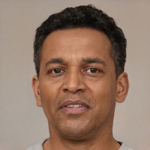 Neutral latino adult male with short  black hair and brown eyes