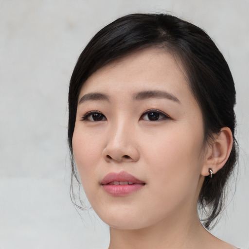 Joyful asian young-adult female with medium  black hair and brown eyes
