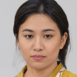 Joyful asian young-adult female with medium  brown hair and brown eyes