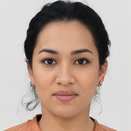 Joyful latino young-adult female with medium  black hair and brown eyes