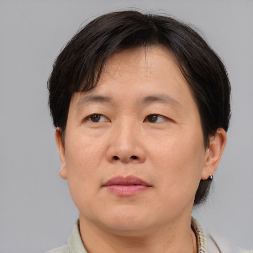 Neutral asian adult male with short  brown hair and brown eyes