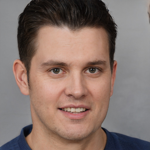 Joyful white young-adult male with short  brown hair and brown eyes