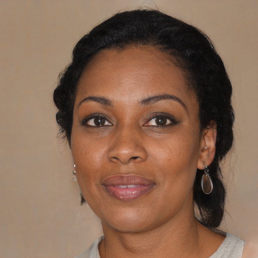 Joyful black adult female with medium  black hair and brown eyes