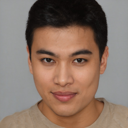 Joyful latino young-adult male with short  brown hair and brown eyes