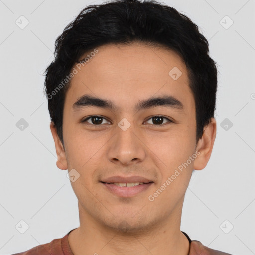 Joyful latino young-adult male with short  black hair and brown eyes