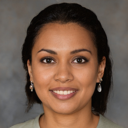 Joyful latino young-adult female with medium  black hair and brown eyes