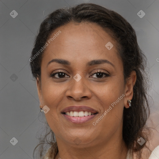 Joyful black adult female with medium  brown hair and brown eyes