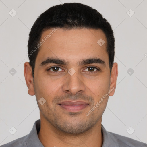 Joyful latino young-adult male with short  black hair and brown eyes