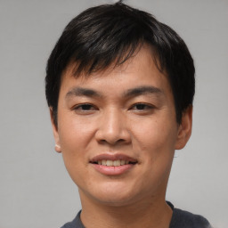 Joyful asian young-adult male with short  black hair and brown eyes