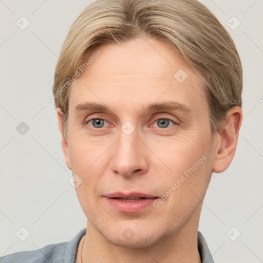 Joyful white adult male with short  brown hair and grey eyes