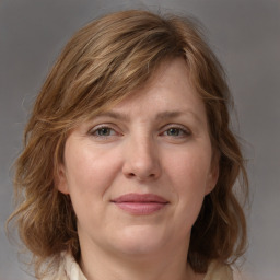 Joyful white adult female with medium  brown hair and grey eyes