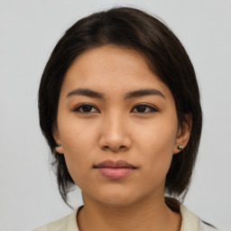 Neutral asian young-adult female with medium  brown hair and brown eyes