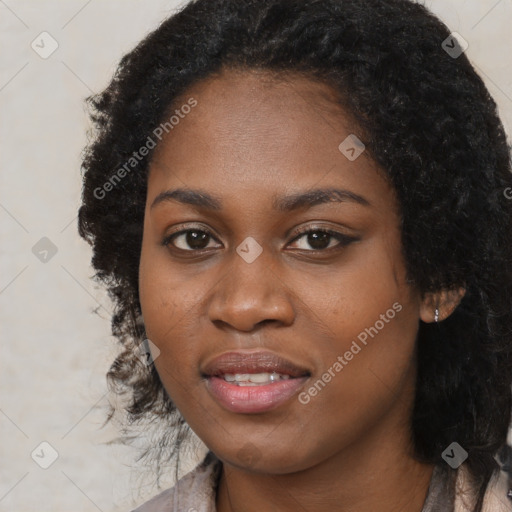 Joyful black young-adult female with long  black hair and brown eyes