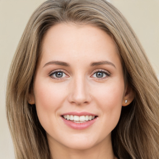 Joyful white young-adult female with long  brown hair and green eyes