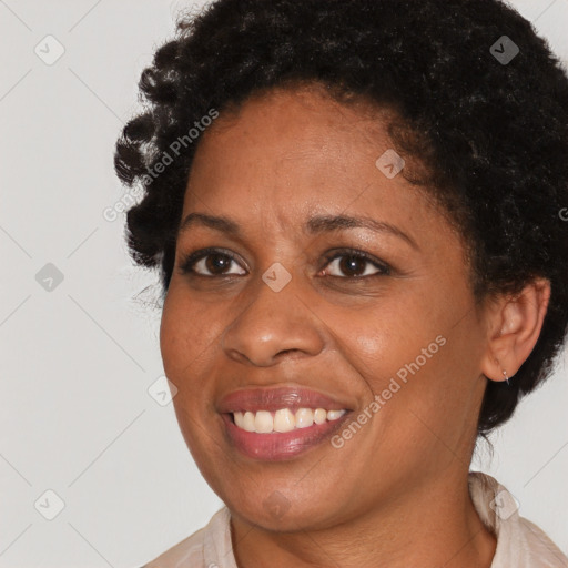 Joyful latino adult female with short  brown hair and brown eyes