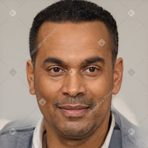 Joyful latino adult male with short  black hair and brown eyes