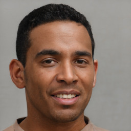 Joyful latino young-adult male with short  brown hair and brown eyes