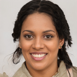 Joyful black young-adult female with medium  brown hair and brown eyes