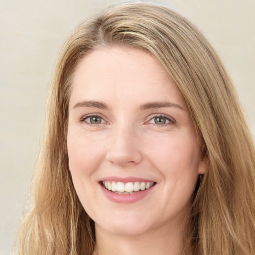 Joyful white young-adult female with long  brown hair and green eyes