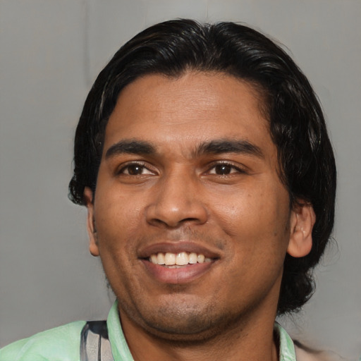 Joyful asian young-adult male with medium  black hair and brown eyes