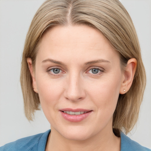 Joyful white young-adult female with medium  brown hair and blue eyes