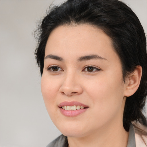 Joyful white young-adult female with medium  black hair and brown eyes