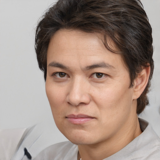 Joyful white adult male with medium  brown hair and brown eyes