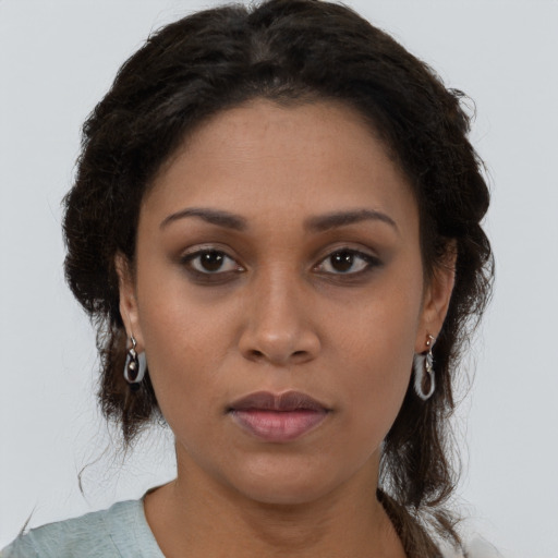 Neutral black young-adult female with medium  brown hair and brown eyes
