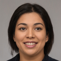 Joyful asian young-adult female with medium  brown hair and brown eyes