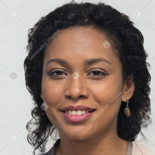 Joyful black young-adult female with long  brown hair and brown eyes