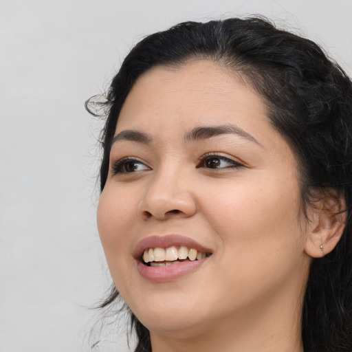 Joyful asian young-adult female with long  black hair and brown eyes