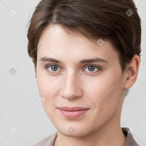 Joyful white young-adult female with short  brown hair and grey eyes