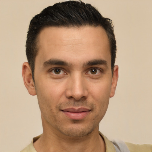 Joyful white young-adult male with short  black hair and brown eyes