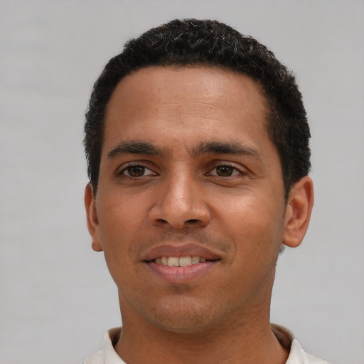 Joyful white young-adult male with short  black hair and brown eyes