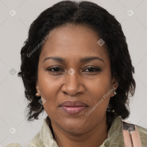 Joyful black adult female with long  brown hair and brown eyes