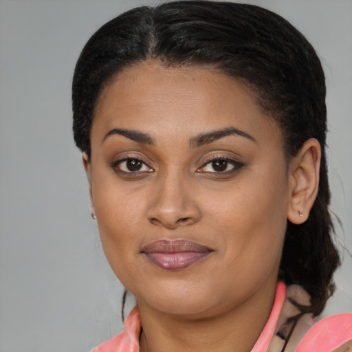 Joyful black young-adult female with medium  brown hair and brown eyes