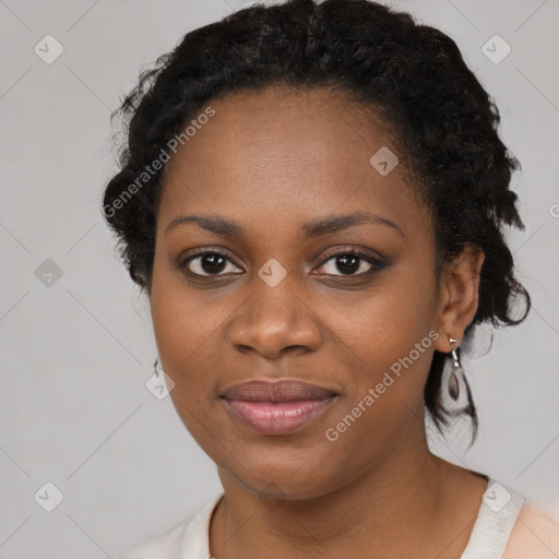 Joyful black young-adult female with medium  black hair and brown eyes