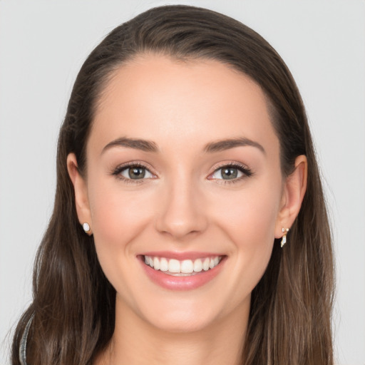 Joyful white young-adult female with long  brown hair and grey eyes