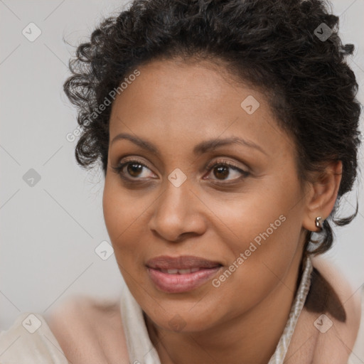 Joyful black adult female with short  brown hair and brown eyes