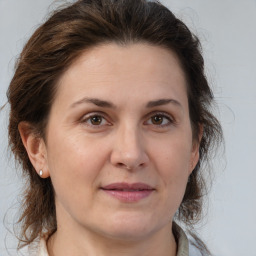 Joyful white adult female with medium  brown hair and brown eyes