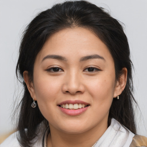 Joyful asian young-adult female with medium  brown hair and brown eyes