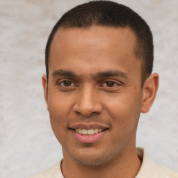 Joyful latino young-adult male with short  brown hair and brown eyes