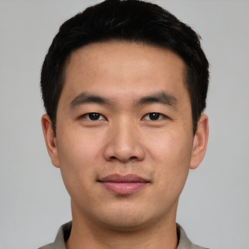 Joyful asian young-adult male with short  black hair and brown eyes