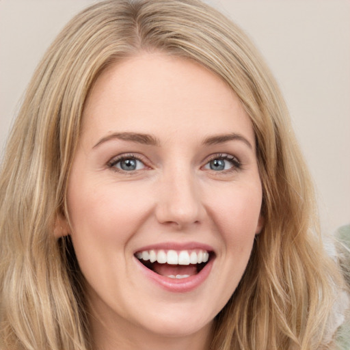 Joyful white young-adult female with long  brown hair and green eyes