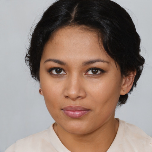 Joyful latino young-adult female with medium  brown hair and brown eyes