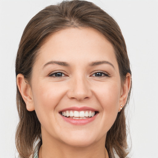 Joyful white young-adult female with medium  brown hair and grey eyes