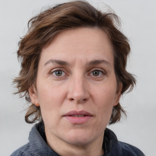 Joyful white adult female with medium  brown hair and grey eyes