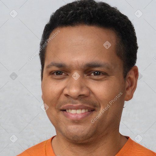 Joyful latino young-adult male with short  brown hair and brown eyes